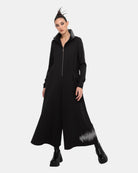 LEEZZA OZAI N KÜ GILDA schwarzer Jumpsuit aus dehnbarer Viskose mit weitem Bein, Frontreißverschluss und grauem Grafikprint.