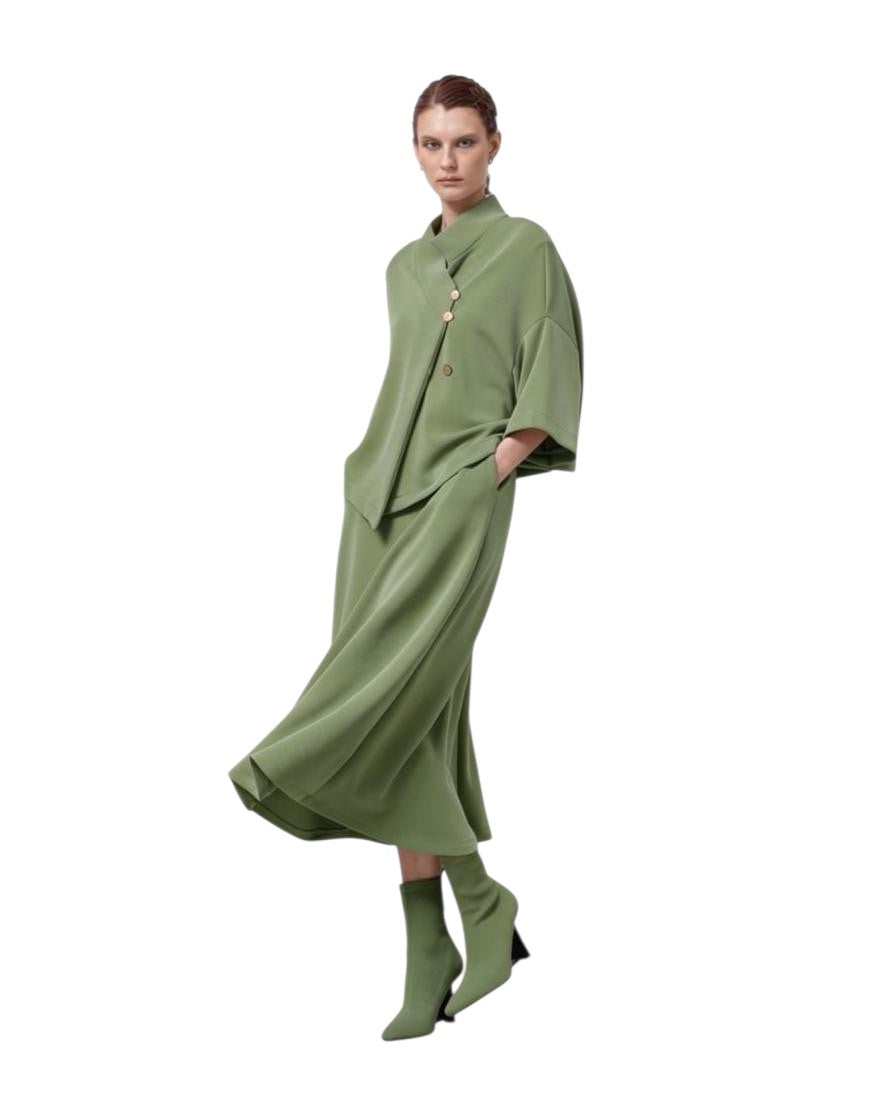 LEEZZA model wearing a sage green LOTUS EATERS AGONION oversized modal jersey vest with asymmetrical button closure.